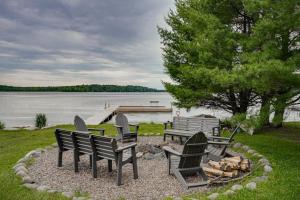 a group of chairs and a fire pit next to a lake at Island View I in Eagle River