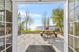an open door to a patio with a picnic table at North Twin Lake House in Phelps