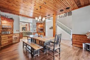 a dining room with a wooden ceiling and a table and chairs at North Twin Lake House in Phelps