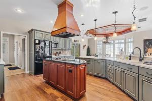a large kitchen with a large island in the middle at North Twin Lake House in Phelps