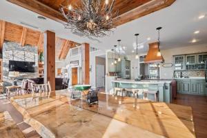 a large kitchen and living room with a dining table at North Twin Lake House in Phelps +46 photos