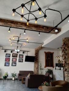 a living room with couches and tables and lights at Hotel CHOLOA in Cholula