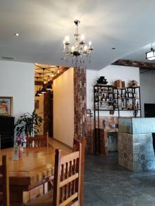 a dining room with a table and a chandelier at Hotel CHOLOA in Cholula +90 photos