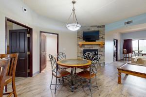 a dining room and living room with a table and chairs at Chula Vista Condo, Unit 2344 in Wisconsin Dells