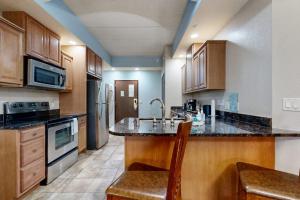 a kitchen with wooden cabinets and a counter top at Chula Vista Condo, Unit 2344 in Wisconsin Dells
