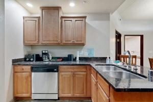 a kitchen with wooden cabinets and a sink at Chula Vista Condo, Unit 2344 in Wisconsin Dells