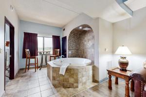 a large bathroom with a tub and a table at Chula Vista Condo, Unit 2344 in Wisconsin Dells +16 photos