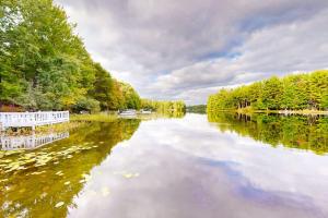 a river with trees and reflections in the water at Northwoods Resort in Woodruff
