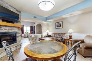 a living room with a table and a fireplace at Chula Vista Condo 2344 and 2346 in Wisconsin Dells