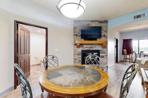 a dining room with a table and a fireplace at Chula Vista Condo 2344 and 2346 in Wisconsin Dells