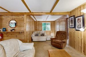 a living room with a couch and a chair at Quaint Lake Escape in Eagle River