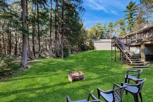 a yard with two chairs and a fire pit at Quaint Lake Escape in Eagle River