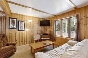 a living room with a couch and a table at Quaint Lake Escape in Eagle River