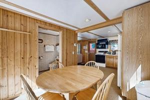 a dining room with a wooden table and chairs at Quaint Lake Escape in Eagle River +16 photos