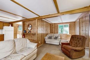 a living room with a couch and a chair at Quaint Lake Escape in Eagle River