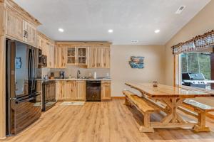 a kitchen with wooden cabinets and a wooden table at The Wilderness in Conover