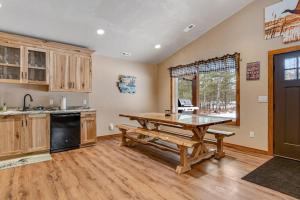 a kitchen with a wooden table and a wooden floor at The Wilderness in Conover