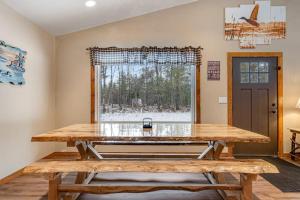 a large wooden table in a room with a window at The Wilderness in Conover
