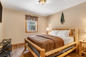 a bedroom with a bed with a wooden bed frame at The Wilderness in Conover +43 photos