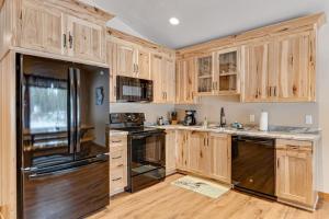 a kitchen with wooden cabinets and stainless steel appliances at The Wilderness in Conover