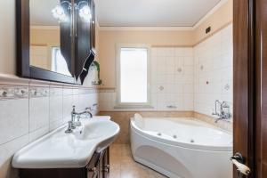 a bathroom with a tub and a sink at Casa Amica in Avola