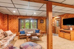 a living room with a couch and a tv at Loon's Landing in Mercer
