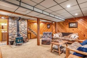 a living room with a fireplace and a stone wall at Loon's Landing in Mercer