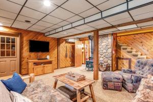 a living room with a couch and a table and a tv at Loon's Landing in Mercer