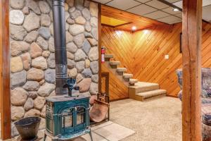 a room with a stone wall and a wood stove at Loon's Landing in Mercer +27 photos