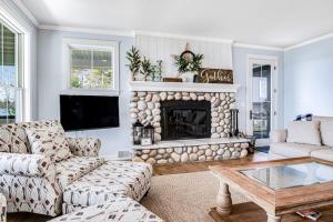 a living room with a couch and a fireplace at Summer Breeze in Sayner