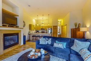 a living room with a blue couch and a fireplace at Lake Minocqua Lakeview in Minocqua