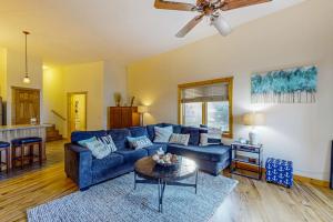 a living room with a blue couch and a table at Lake Minocqua Lakeview in Minocqua