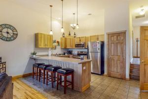 a kitchen with a counter with stools and a refrigerator at Lake Minocqua Lakeview in Minocqua