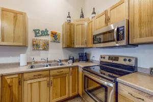 a kitchen with wooden cabinets and a stove top oven at Lake Minocqua Lakeview in Minocqua +22 photos