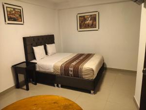 a small bedroom with a bed in a room at Hostal Ñustas INN in Machu Picchu +2 photos
