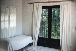 a bedroom with a bed and a large window at Encantadora casa de campo in Ciudad Lujan de Cuyo +63 photos