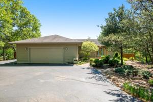 a house with a garage on a driveway at Par for the Course in New Rome