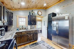 a kitchen with a stainless steel refrigerator and wooden cabinets at The Korn Krib- Main level in Oxbo +15 photos