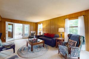a living room with a couch and a table at Turtle Bay in Minocqua