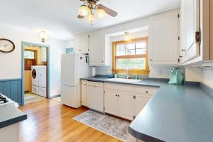 a kitchen with white cabinets and a white refrigerator at Turtle Bay in Minocqua