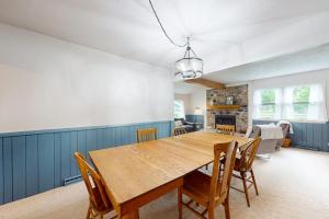 a dining room with a wooden table and chairs at Turtle Bay in Minocqua +50 photos