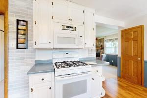 a kitchen with white cabinets and a stove top oven at Turtle Bay in Minocqua