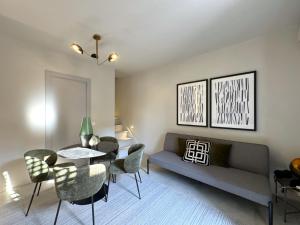 a living room with a couch and a table and chairs at Casa Lumae in Noto