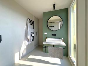 a bathroom with a white sink and a mirror at Casa Lumae in Noto +15 photos
