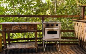 a stove and a table on a deck at Paraty Paradiso in Parati-Mirim