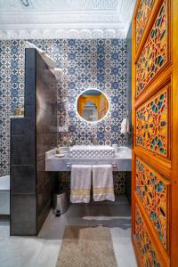 a bathroom with a sink and a mirror at Riad Nadalinn in Marrakesh +122 photos