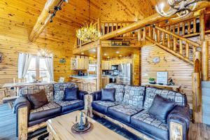 a living room with a couch and a table at Blissful Deer Cabin in Friendship
