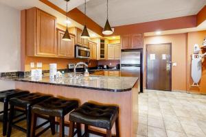 a kitchen with a large island with bar stools at Chula Vista Condo 2632/2634 in Wisconsin Dells