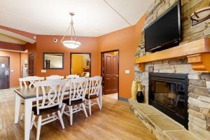 a dining room with a table and a fireplace at Chula Vista Condo 2632/2634 in Wisconsin Dells