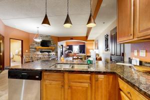 a kitchen with a sink and a counter top at Chula Vista Condo 2632/2634 in Wisconsin Dells +42 photos